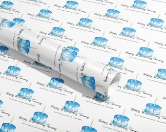 May include: White wrapping paper with a repeating pattern of blue watercolor cake illustrations and the text "Happy 1st Birthday Tommy Love from Granny & Grandad".