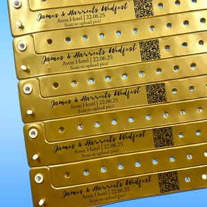 May include: Gold wristbands with the text "James & Harriets Wedfest" and event details. Each band has a QR code and the text "Scan to upload pics!". The bands are for an event at the Avon Hotel on 22 June 2025.