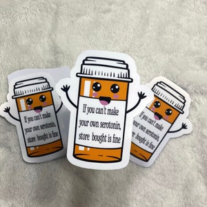 May include: Three white stickers with a cartoon pill bottle character. The pill bottle is orange and white with a black lid. The pill bottle has a happy face and arms. The text on the sticker reads "If you can't make your own serotonin, store bought is fine."