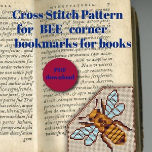 May include: Cross stitch pattern for a bee corner bookmark. The bee is yellow and brown with blue wings. The pattern is on a beige background with a red border.