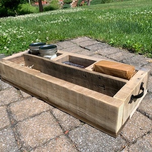 May include: A rustic wooden organizer with three compartments, a metal handle, and two glass jars. The organizer is made from reclaimed wood and has a natural, weathered finish.