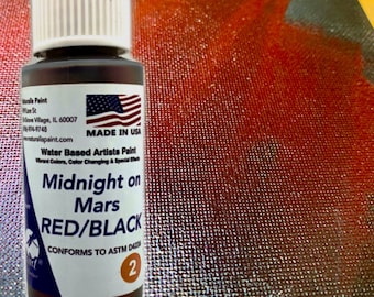 May include: A bottle of "Midnight on Mars" water-based artist paint, red and black in color. The label includes the text "Made in USA" and the brand name "Inrals Paint". The paint is designed for vibrant colors and color changing effects.