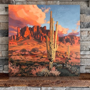 May include: A painting of a desert landscape with a large saguaro cactus in the foreground. The sky is a vibrant orange and pink, with fluffy white clouds. The mountains in the background are a reddish-brown color.