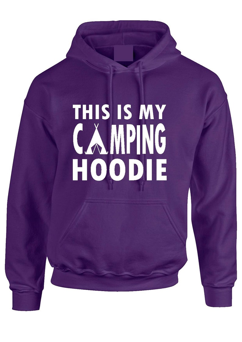 May include: A purple hoodie with a front pocket and a drawstring hood. The white text on the front reads "THIS IS MY CAMPING HOODIE" with a tent graphic. The hoodie is made of a soft material.