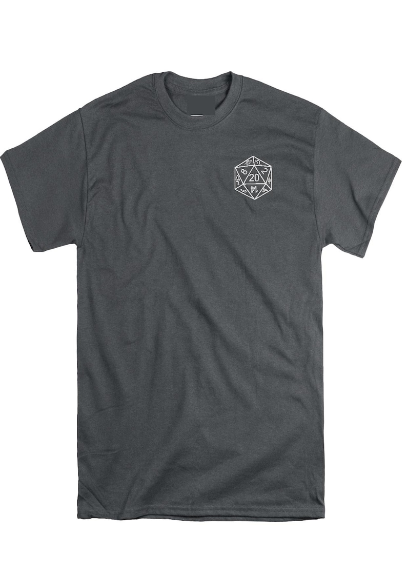 May include: A dark charcoal gray short-sleeve t-shirt featuring a white line-art graphic of a twenty-sided die on the upper left chest. The die displays the number 20 at the top, with other visible numbers including 8, 2, 14, 4, and 9.