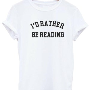 May include: White t-shirt with black text that reads "I'd rather be reading".
