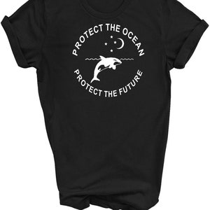 May include: Black t-shirt with a white graphic design of an orca jumping out of the water with a crescent moon and stars above. The text reads "Protect the Ocean Protect the Future".