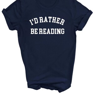 May include: A navy blue t-shirt with white text that reads "I'd rather be reading".
