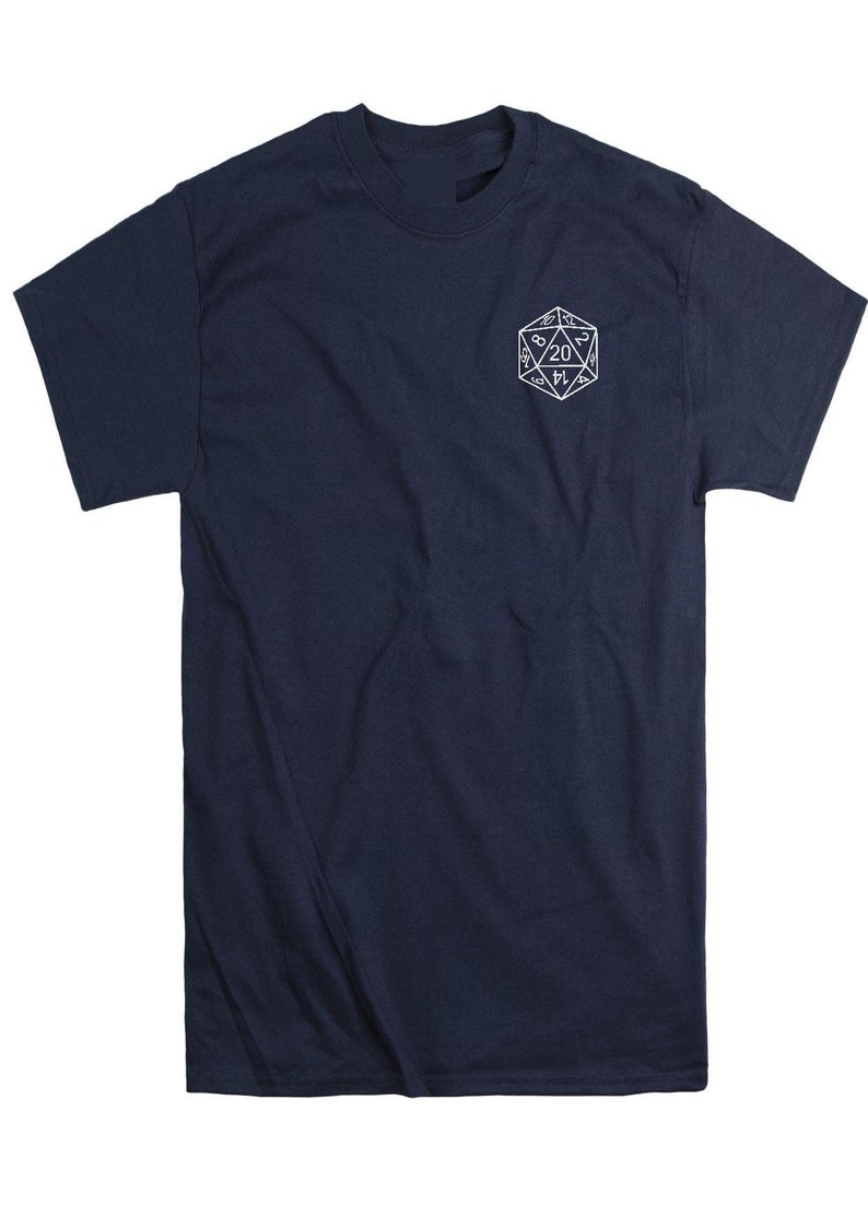 May include: A navy blue short-sleeve t-shirt featuring a white line-art graphic of a twenty-sided die on the upper left chest. The die displays various numbers, with the number 20 prominently centered within the geometric shape.