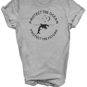 May include: Gray t-shirt with a black graphic of an orca jumping out of the water with a crescent moon and stars above. The text "Protect the Ocean Protect the Future" is in a circle around the orca.