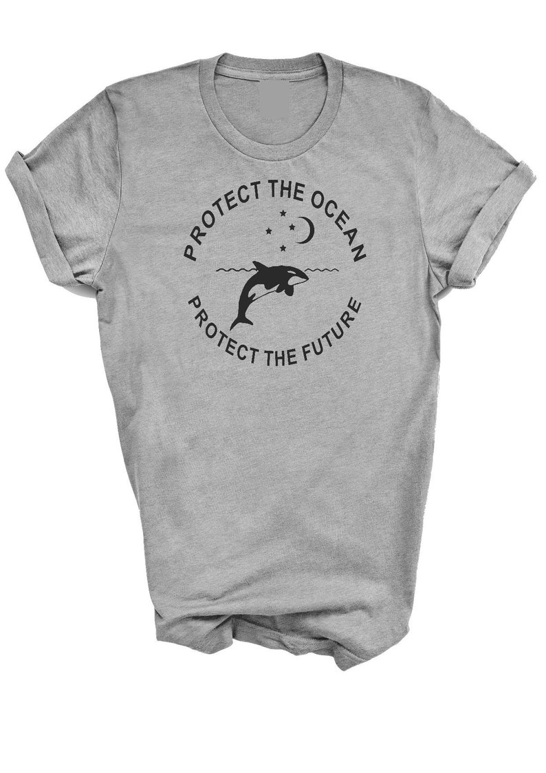 May include: Gray t-shirt with a black graphic of an orca jumping out of the water with a crescent moon and stars above. The text "Protect the Ocean Protect the Future" is in a circle around the orca.