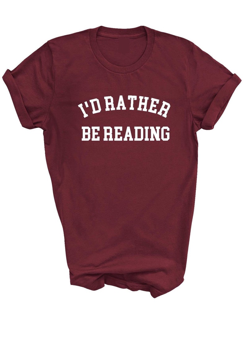 May include: Burgundy t-shirt with white text that reads "I'd rather be reading."