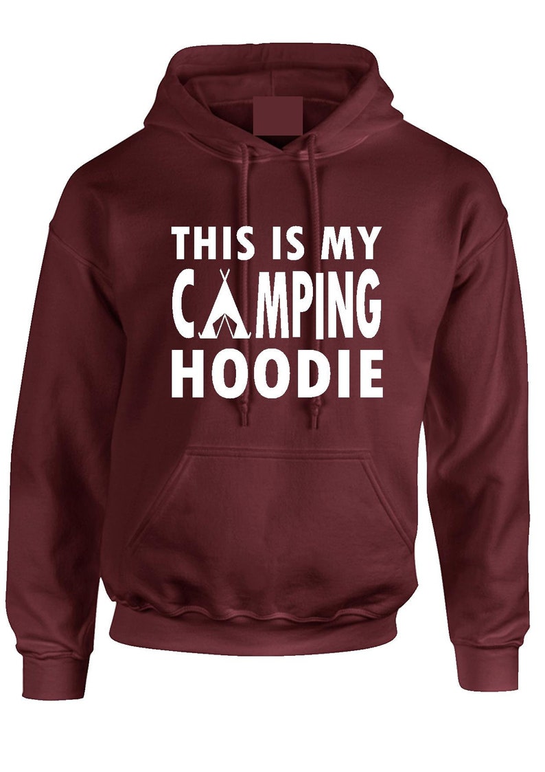 May include: A maroon hoodie with a front pocket and a drawstring hood. The white text on the front reads "THIS IS MY CAMPING HOODIE" with a tent graphic. A comfortable garment for outdoor enthusiasts.