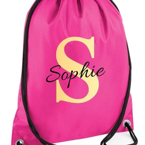 drawstring waterproof bag in hot pink colour, with a gold monogram letter and script name
