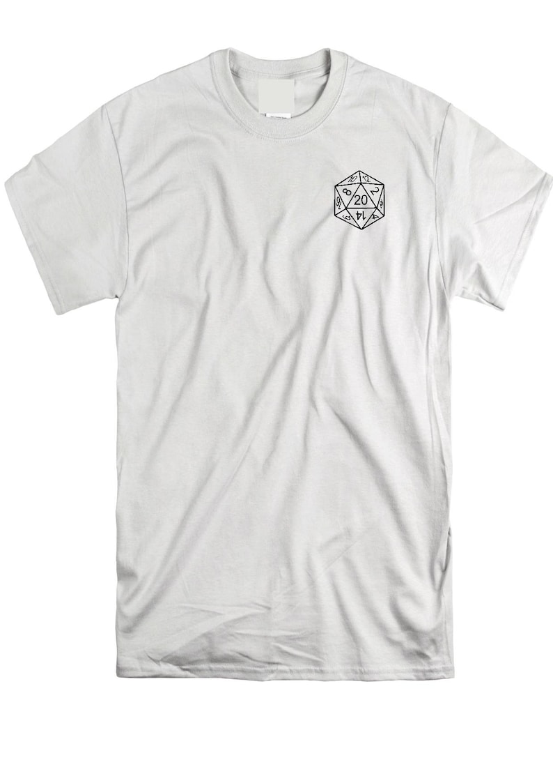May include: A white short-sleeve t-shirt featuring a black line art graphic of a twenty-sided die on the upper left chest area. The die displays the number 20 prominently at the top, with other numbers visible on the triangular faces of the shape.