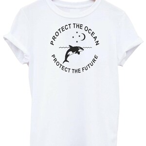 May include: White t-shirt with a black graphic design featuring an orca jumping out of the water with a crescent moon and stars above. The text reads "Protect the Ocean, Protect the Future."