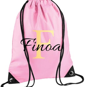 drawstring waterproof bag in pale pink colour , with a gold monogram letter and script name