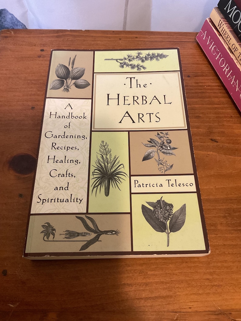 May include: A rectangular book titled The Herbal Arts by Patricia Telesco. The cover features a grid layout with light green and tan panels, each displaying black and white botanical illustrations of various plants, herbs, and flowers.