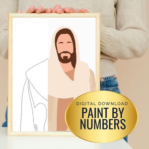 May include: A framed print with a minimalist illustration of a religious figure, depicted with a beard and robe in beige, brown, and white. The print includes the text "DIGITAL DOWNLOAD PAINT BY NUMBERS" on a gold oval sticker at the bottom.