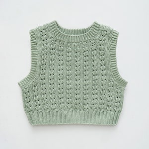 May include: A light green crochet sleeveless top with a delicate openwork pattern.