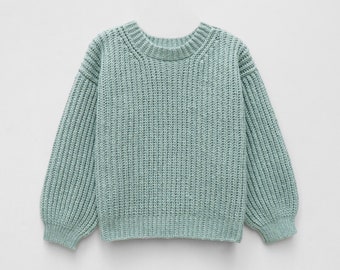 May include: A light sage green long-sleeve sweater featuring a chunky ribbed knit texture, a rounded crew neckline, and dropped shoulder seams. The garment has a thick ribbed hem and cuffs, providing a structured silhouette with a consistent knit pattern throughout the body and sleeves.
