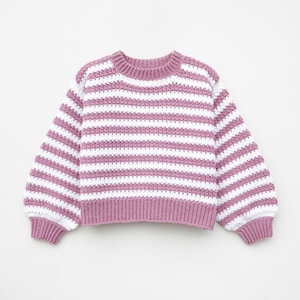 May include: A pink and white striped crocheted sweater with long sleeves.