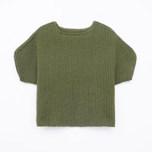 May include: Olive green knit sweater with short sleeves. The sweater has a crew neck and a boxy silhouette. The fabric appears to be a medium-weight knit, suitable for cooler weather. The garment is displayed on a white background.