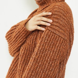 May include: A brown turtleneck sweater with a ribbed knit texture.