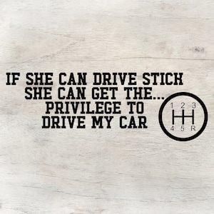 May include: A black and white graphic on a wood background with the text "If she can drive stick she can get the... privilege to drive my car." and a black and white illustration of a car's gear shift.