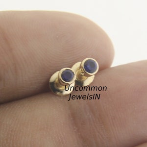 Experience the timeless elegance of our 2.5mm blue sapphire bezel-set stud earrings perfect for daily wear, celebrating September birthdays