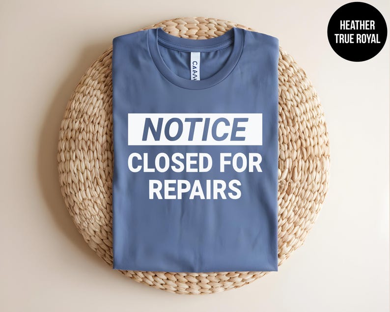May include: A blue t-shirt with white text that reads "NOTICE CLOSED FOR REPAIRS".