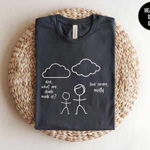 May include: Dark heather grey t-shirt with a white graphic of a stick figure asking "dad, what are clouds made of?" and another stick figure answering "linux servers, mostly".