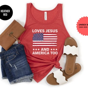 May include: Heather red tank top with a distressed American flag and the text "Loves Jesus and America Too".