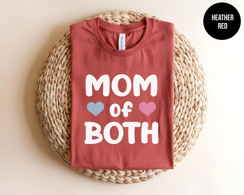 May include: Heather red t-shirt with the text "MOM of BOTH" in white with a blue heart and a pink heart.