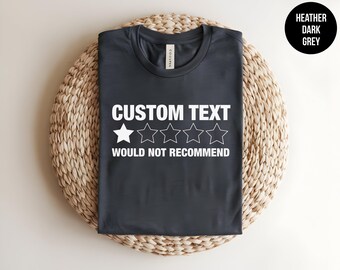 May include: A heather dark grey t-shirt featuring white text that reads CUSTOM TEXT above a single filled-in star and four empty star outlines, with the text WOULD NOT RECOMMEND printed below the stars in a bold, sans-serif font.