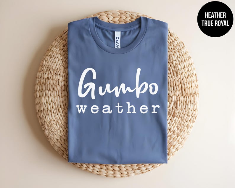 May include: A blue t-shirt with the text "Gumbo weather" in white lettering.