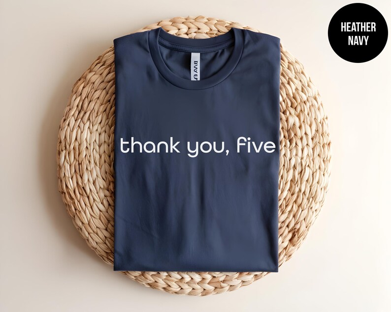 May include: A heather navy blue t-shirt with the text "thank you, five" printed in white on the front.