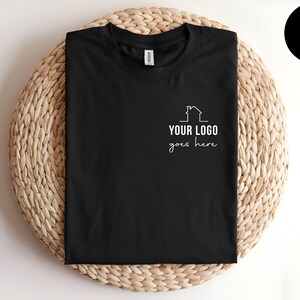 May include: Black t-shirt with a white outline of a house and the text "YOUR LOGO goes here".