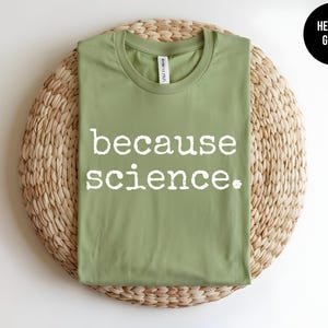 May include: A heather green t-shirt with the text "because science." printed in white.