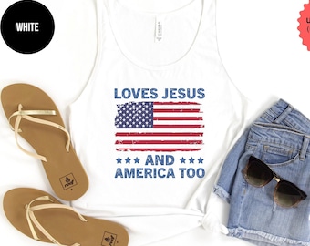 May include: White tank top with a distressed American flag graphic and the text "Loves Jesus and America Too".