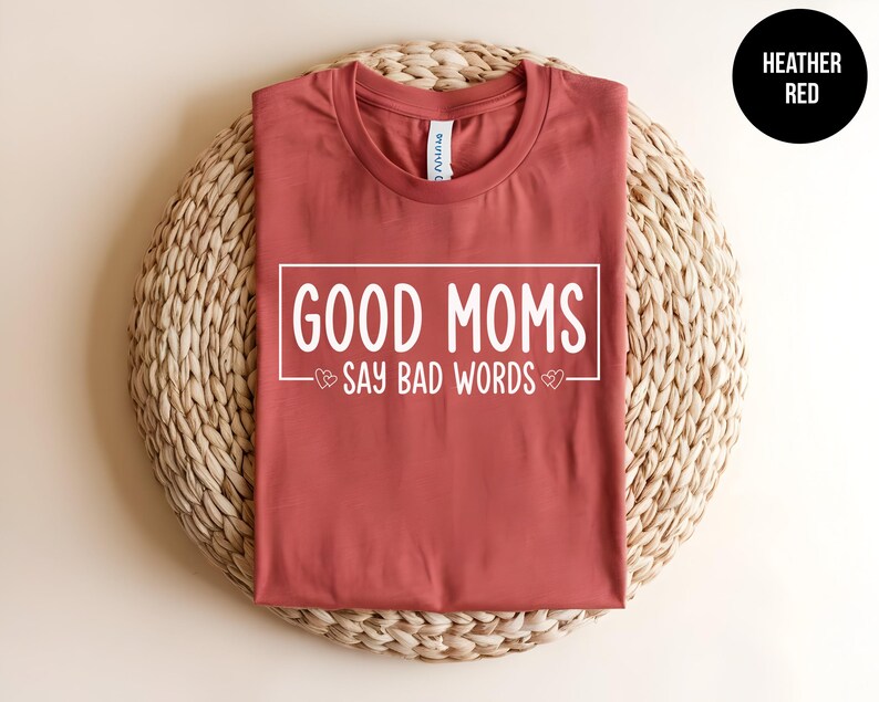May include: Heather red t-shirt with the text "Good Moms Say Bad Words" printed in white.
