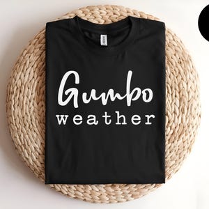 May include: Black t-shirt with white text that reads "Gumbo weather".