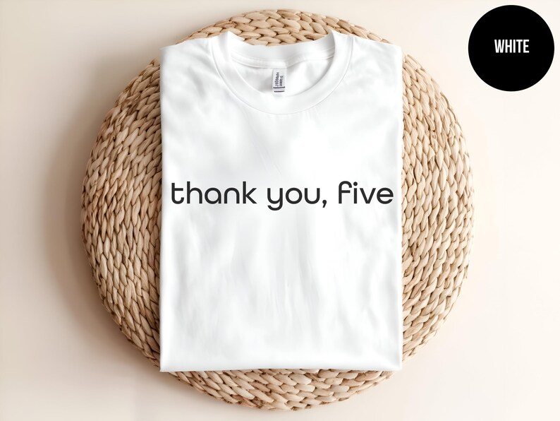 May include: White t-shirt with the text "thank you, five" printed in black.