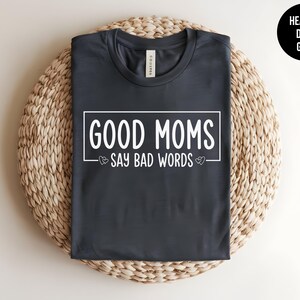 May include: Heather dark grey t-shirt with the text "Good Moms Say Bad Words" in white lettering.