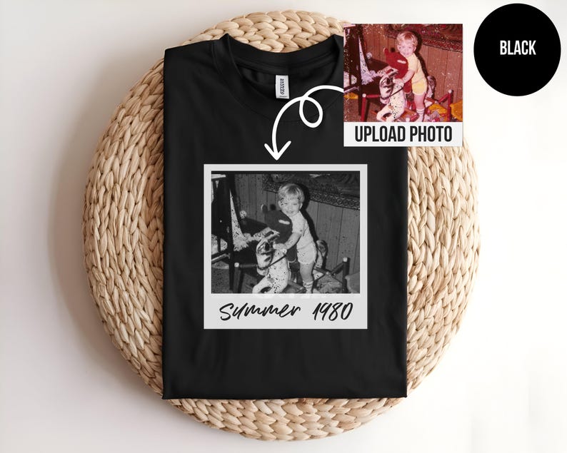 May include: Black t-shirt featuring a black and white photo in a white frame. The photo shows a child on a rocking horse. The text "Summer 1980" is below the photo. A smaller color photo is in the upper right corner, with the text "UPLOAD PHOTO".