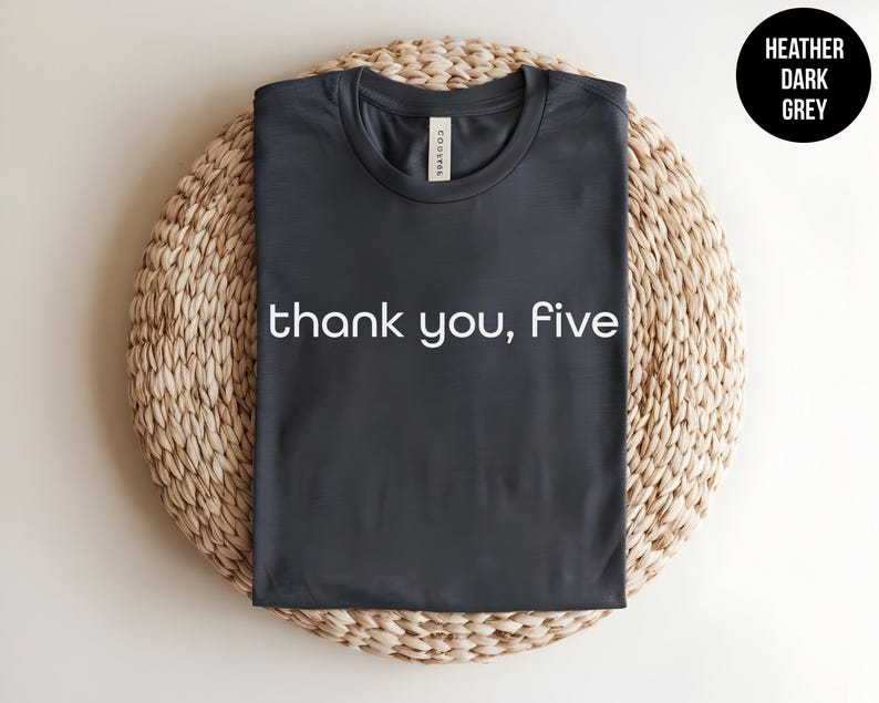 May include: Heather dark grey t-shirt with the text "thank you, five" printed in white.