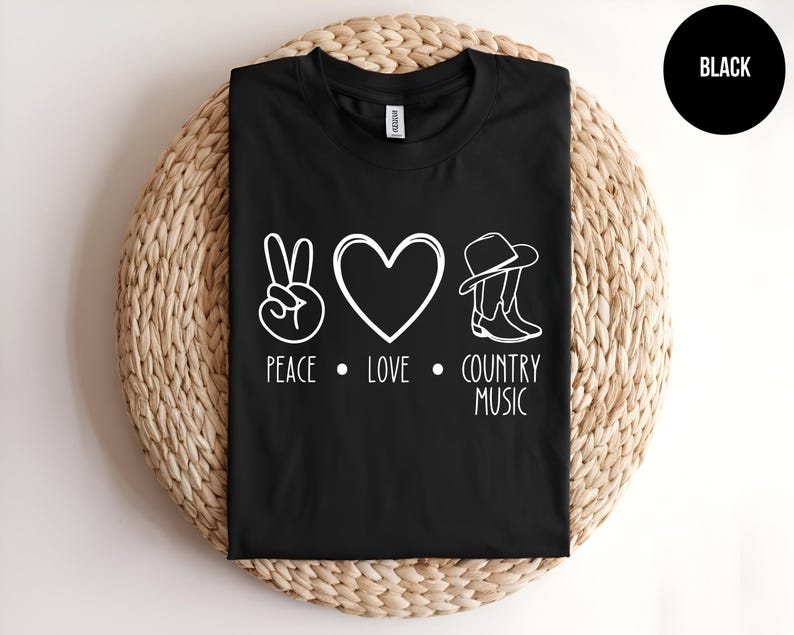 May include: Black t-shirt with a white peace sign, heart, and cowboy boots. The text "Peace, Love, Country Music" is printed below the symbols.