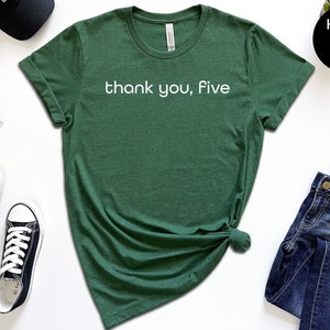 May include: A green t-shirt with the text "thank you, five" in white lettering.
