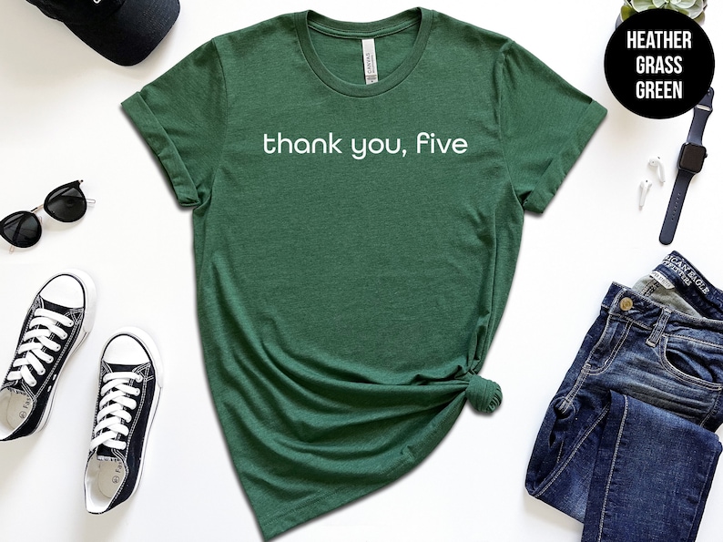 May include: A green t-shirt with the text "thank you, five" in white lettering.