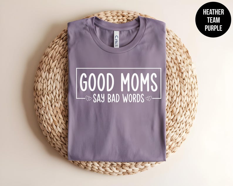 May include: Purple heather t-shirt with the text "Good Moms Say Bad Words" in white lettering.
